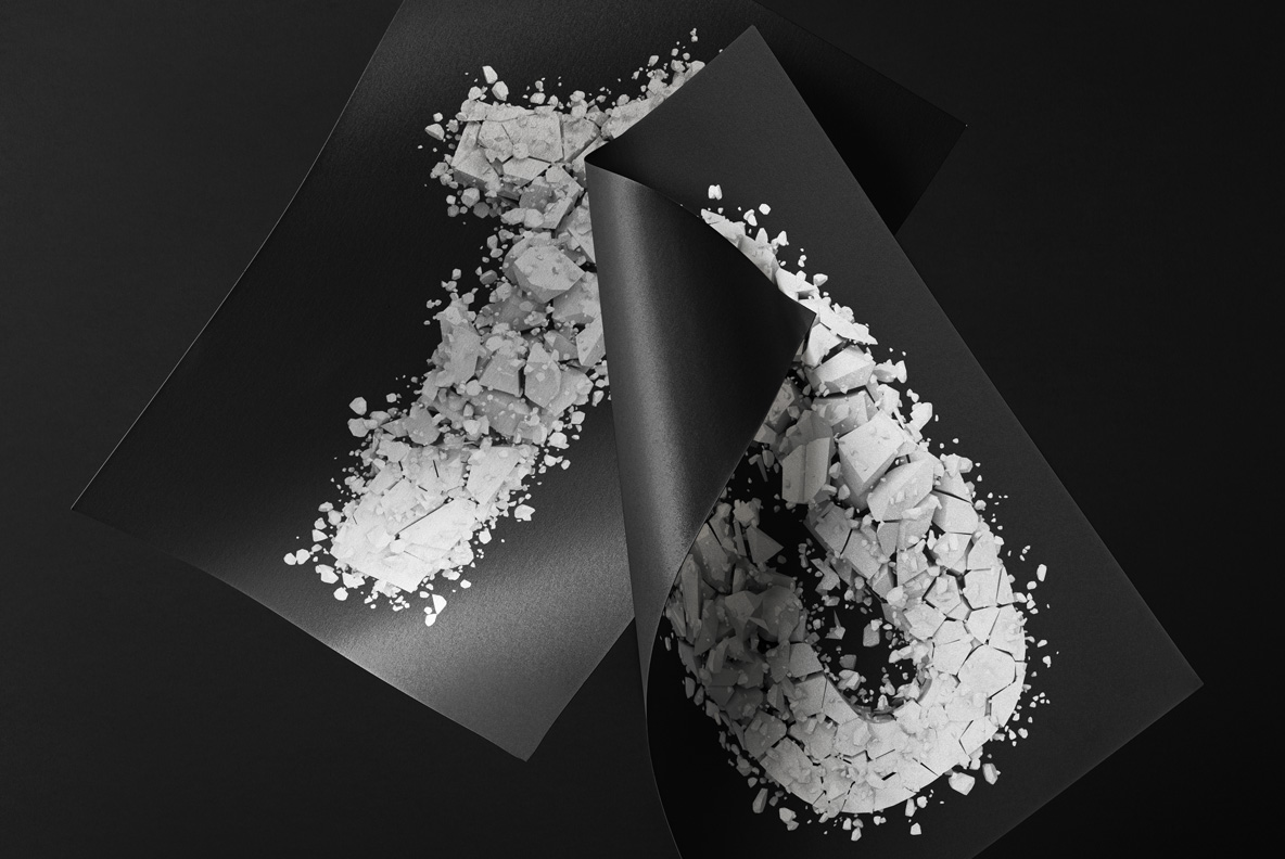 Particle Rock Font on Folded Card Dark folded card with a shattered letter from the Particle Rock Font