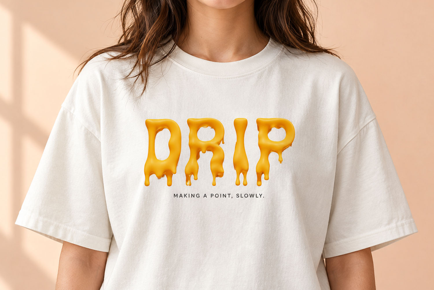Melting Font DRIP T-Shirt White t-shirt worn on a peach background with DRIP printed in the Melting Font