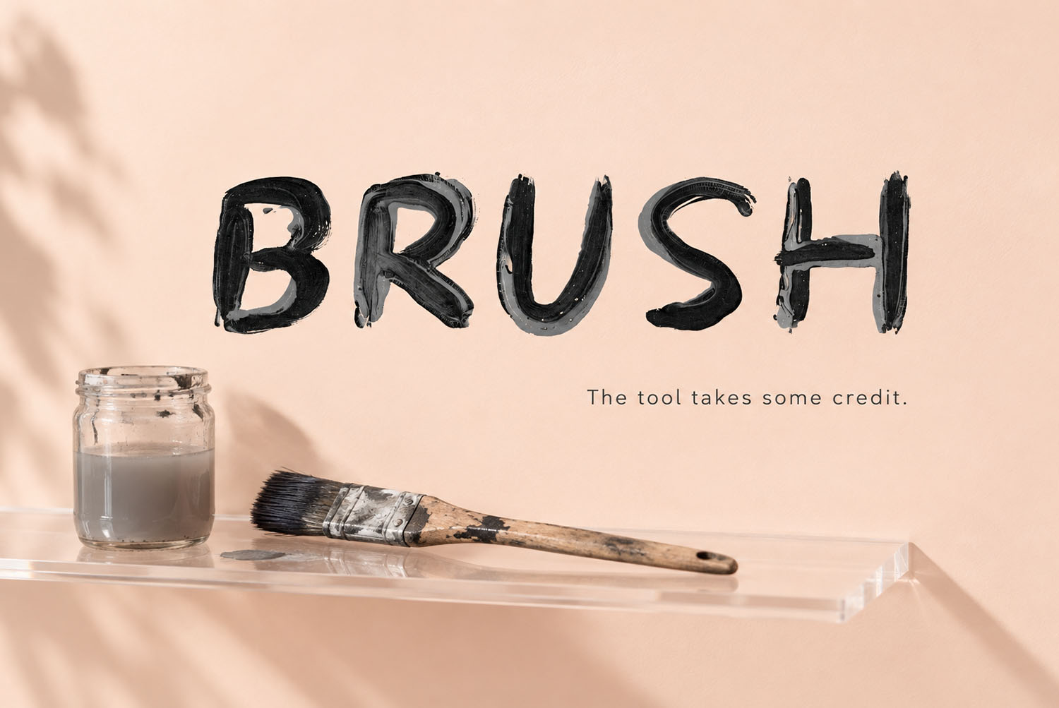 The word BRUSH in the Black Paint Font The word BRUSH painted in the Black Paint Font beside a brush and jar
