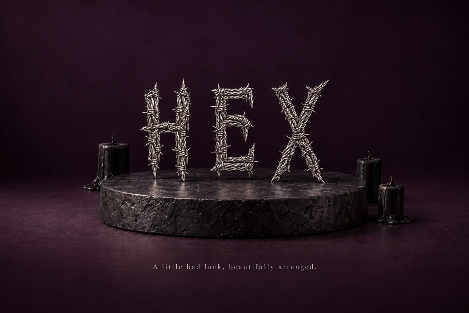 Gothic Barbed Wire Font Spelling HEX on a Stone Plinth Gothic Barbed Wire Font spelling HEX on a stone plinth between two candles