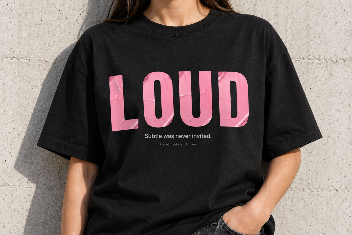 Pink Sticker Font T-Shirt Black t-shirt printed with the word LOUD in the Pink Sticker Font