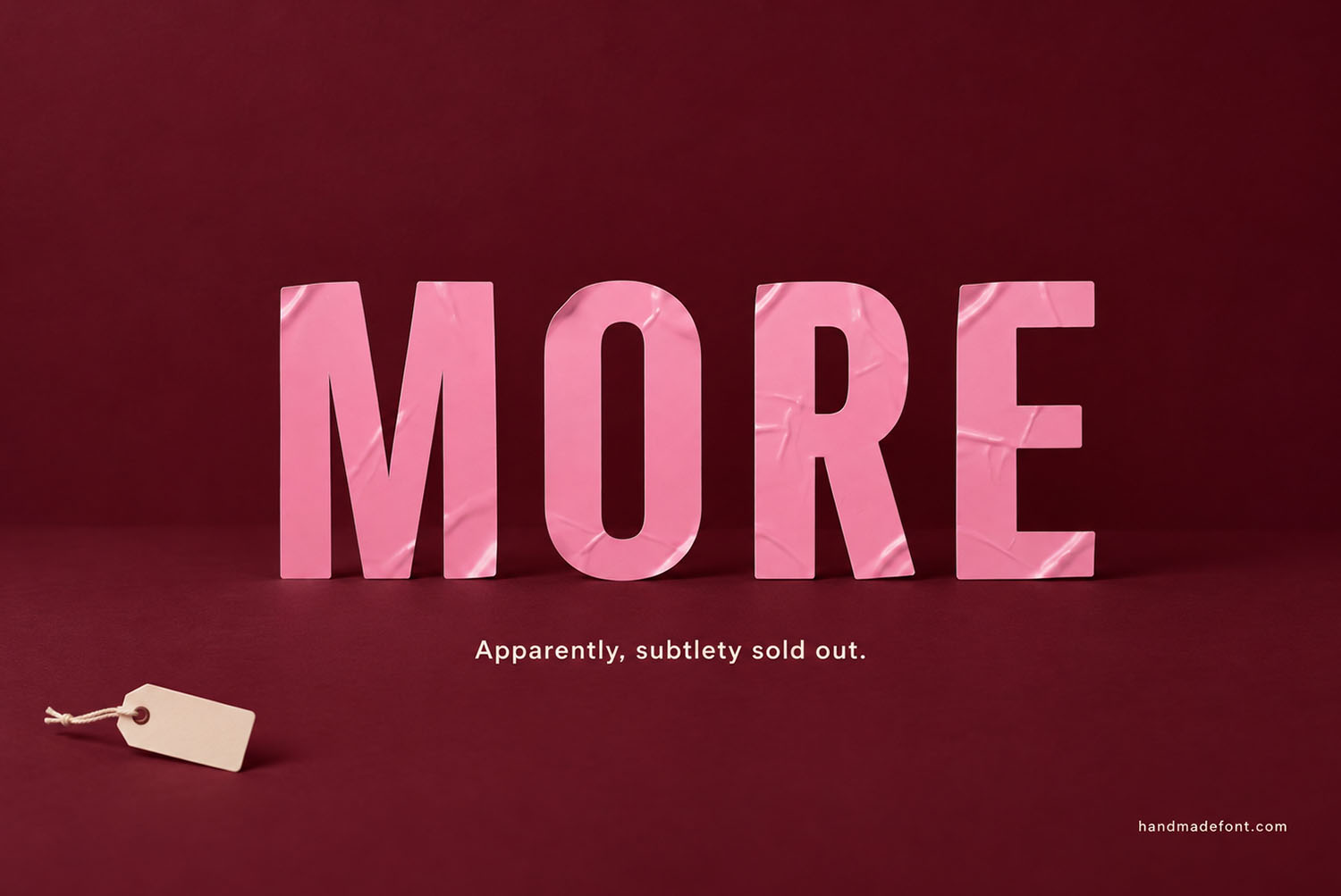 Pink Sticker Font More Lettering The word MORE in the Pink Sticker Font against a deep burgundy background