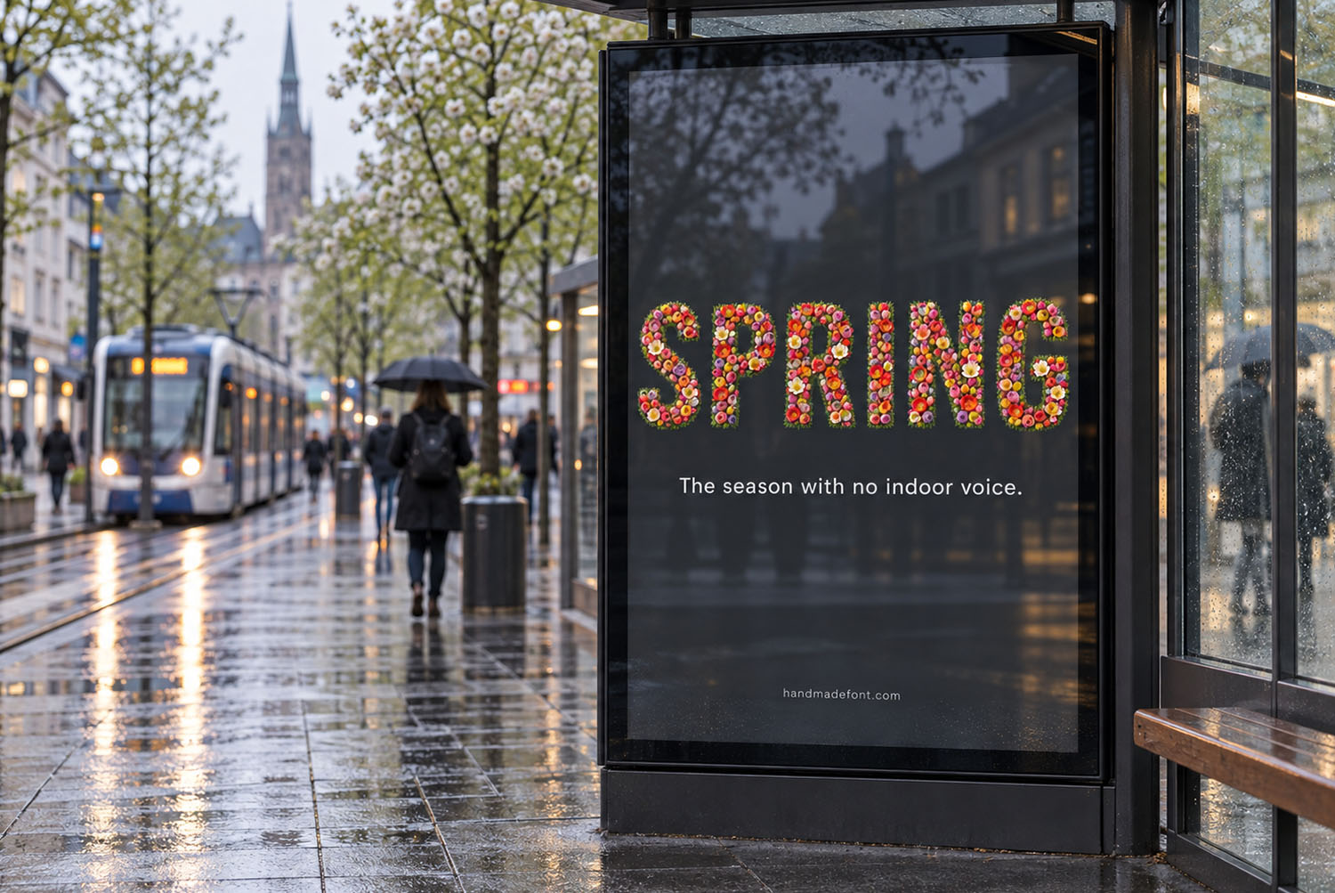 Tulip Font on a city billboard The word SPRING set in the Tulip Font on a rainy city bus stop billboard