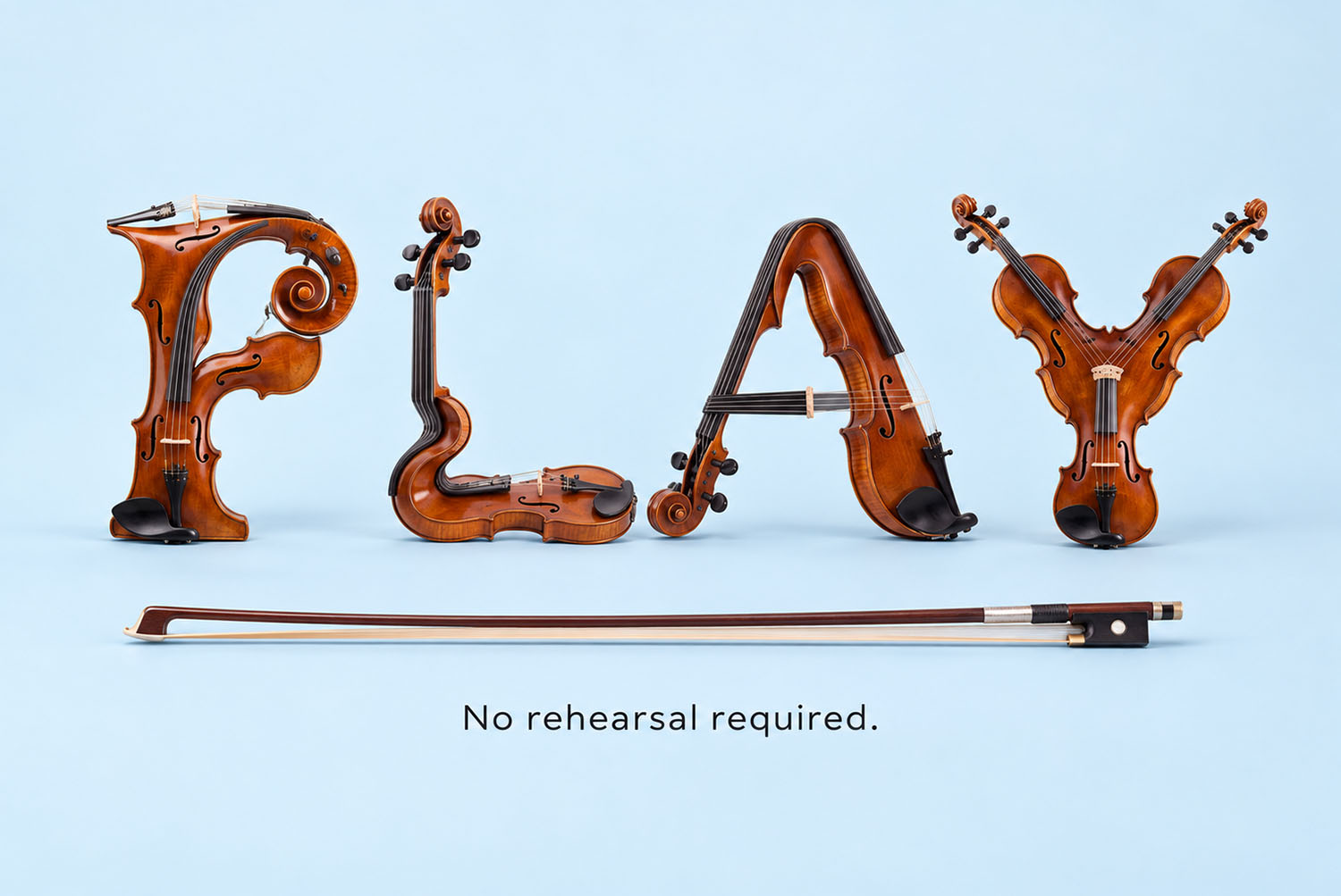 Violin Harmony Font PLAY on Blue PLAY in the Violin Harmony Font on pale blue with a violin bow