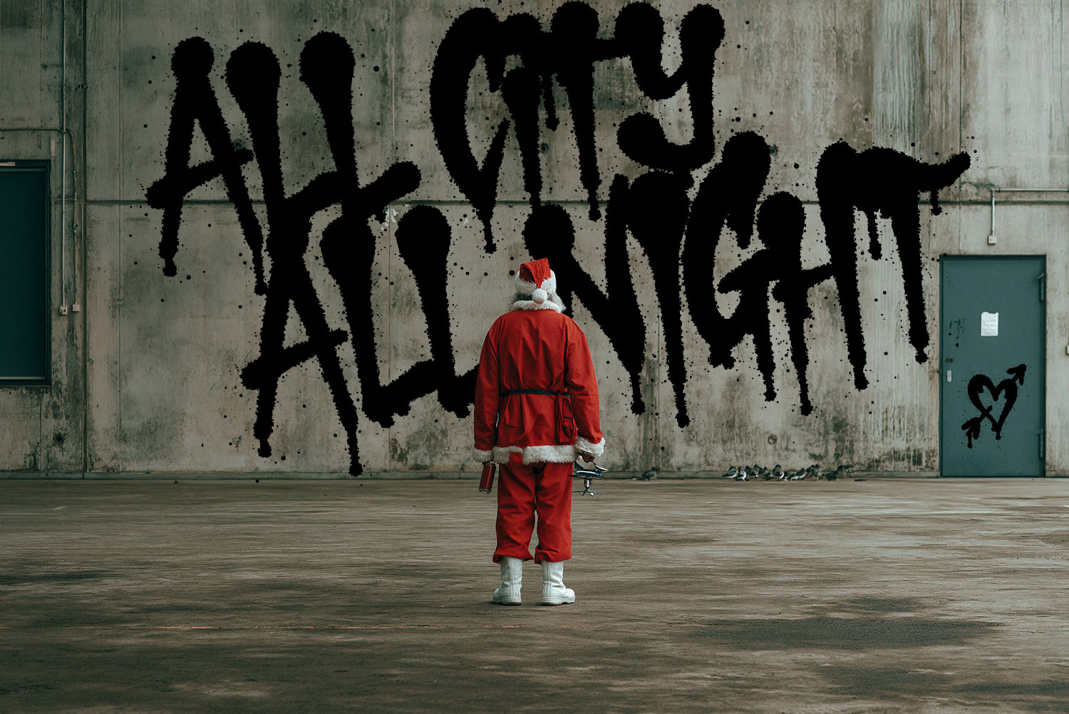 All City All Night in Drip Marker Font ALL CITY ALL NIGHT in the Drip Marker Font on a warehouse wall, a figure in a Santa suit standing below