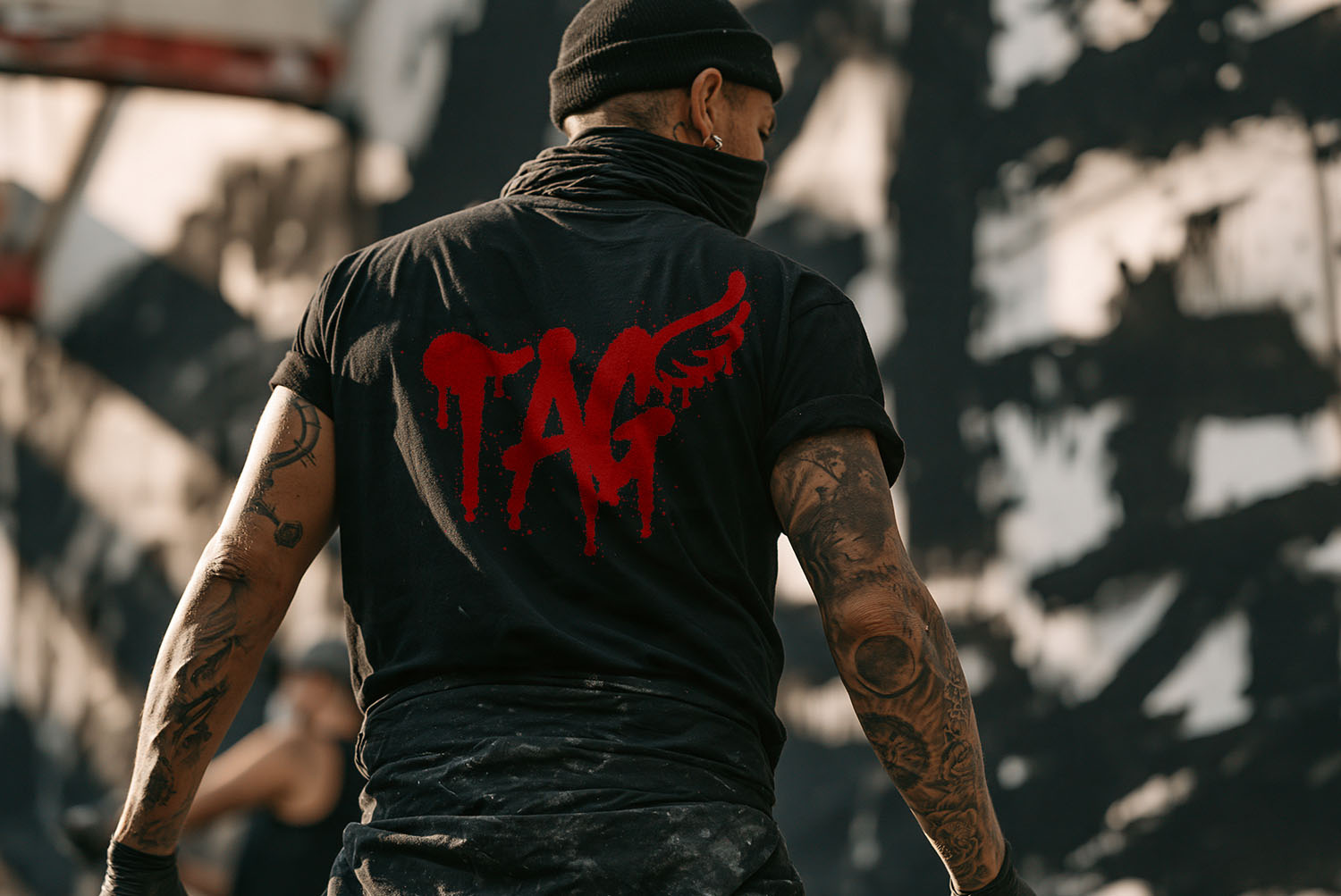 Tag T-Shirt in Drip Marker Font Red dripping TAG in the Drip Marker Font printed on the back of a black t-shirt